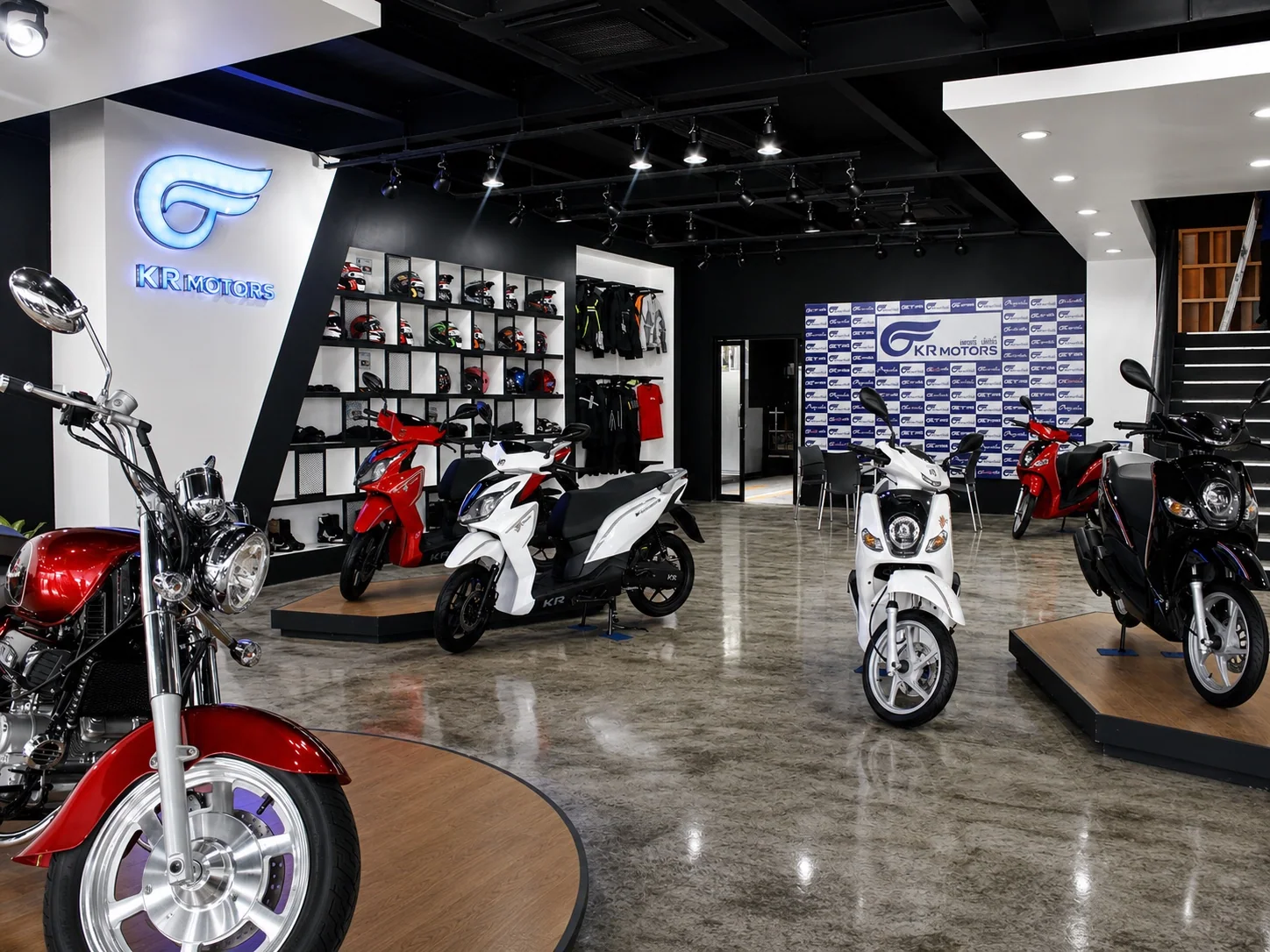 Retouched archival site photograph of the completed KR Motors vehicle display and brand identity zone in Vientiane, July 2017