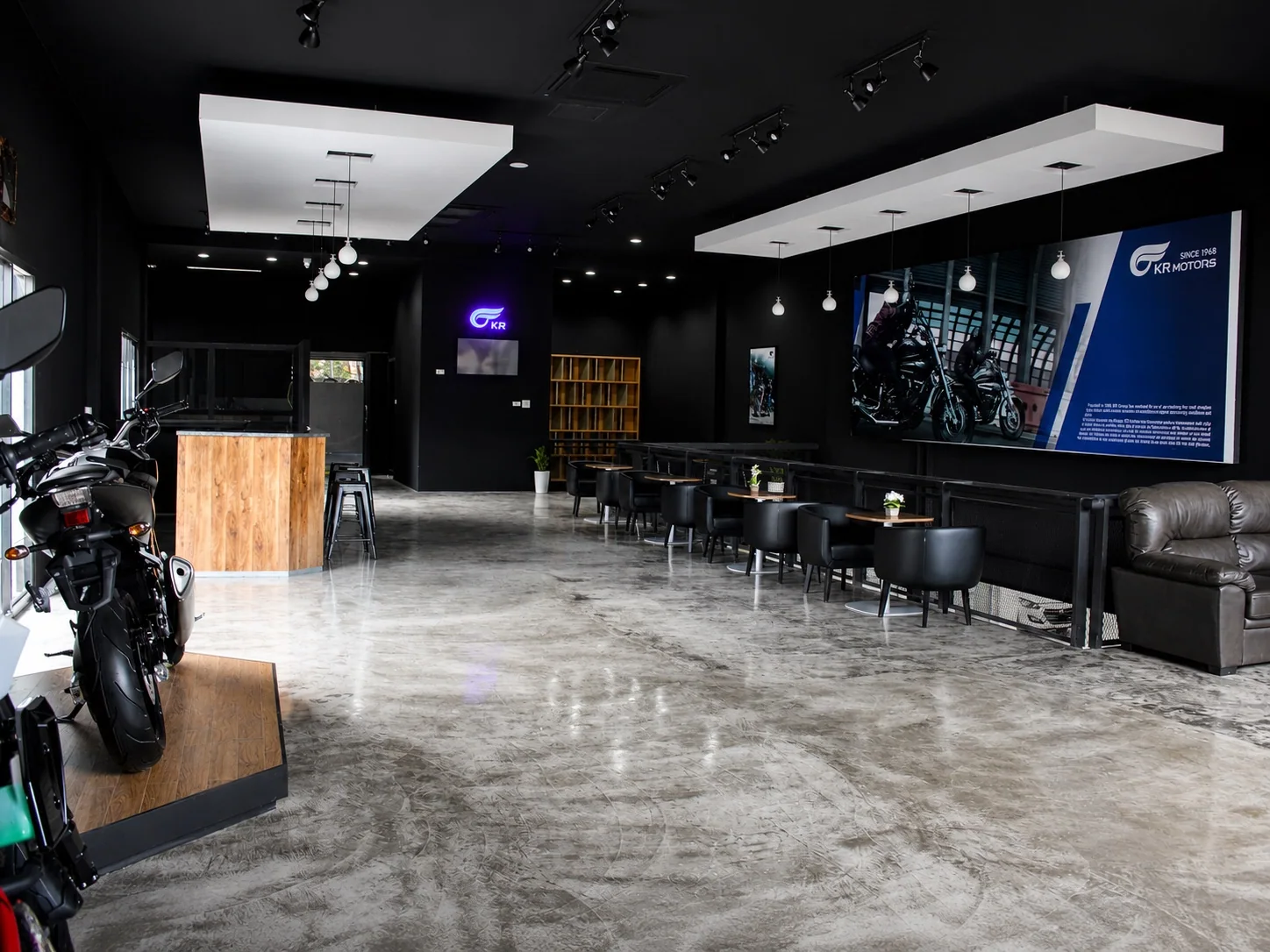 Retouched archival site photograph of the completed KR Motors lounge and customer consultation zone in Vientiane, July 2017